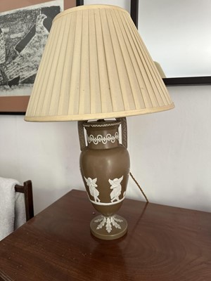 Lot 1729 - 19th century pottery classical urn, brown glaze with applied winged putti, on circular base, now as a table lamp, with shade, 53cm high overall
