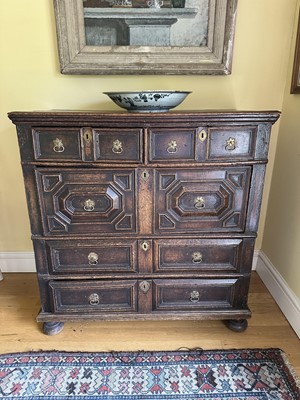 Lot 1780 - 17th century oak geometric chest, two short and three long drawers with brass ring handles, on bun feet