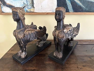 Lot 1781 - Pair of antique Egyptian Revival carved ebonised and gilt mounts in the form of Sphinxes, on rectangular bases