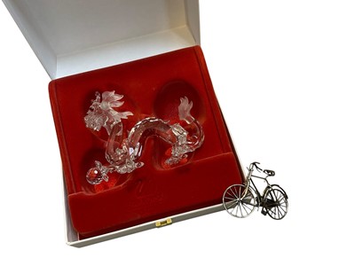 Lot 5324 - Swarovski SCS dragon in box, together with a sterling silver model of a bicycle (2)