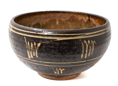 Lot 1838 - *Michael Cardew C.B.E. (1901-1983) for Winchcombe Pottery, circular slipware bowl in black and cream, impressed marks to base, 18cm high x 32cm diameter