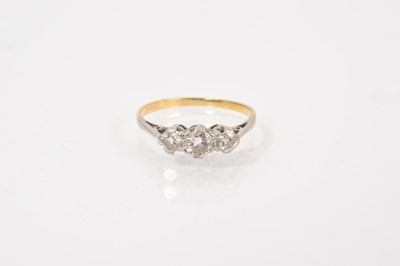 Lot 671 - Diamond three stone ring with three brilliant cut diamonds in a platinum claw setting on 18ct yellow gold shank