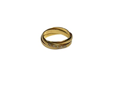Lot 8 - 9ct gold entwined three band ring set with five diamonds