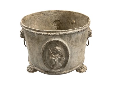 Lot 1873 - 19th century lead planter, circular form with twin lion ring handles, on three paw feet, 30cm diameter x 24cm high