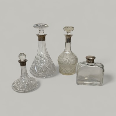 Lot 5044 - Three silver collared decanters and a scent bottle with white metal top (4)