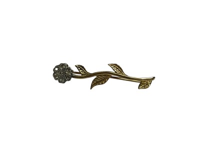 Lot 76 - 9ct gold flower brooch with a diamond set flower head and yellow gold stem and leaves, 4cm