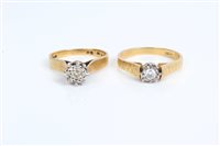 Lot 3402 - Two gold single stone rings - each with a...