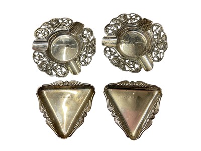 Lot 150 - Pair Edwardian Art Nouveau silver ashtrays with pierced floral decoration, (Birmingham 1908,) and pair 1950s silver triangular dishes, (Birmingham 1959)