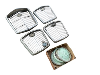 Lot 124 - Four classic Wolseley radiator grills together with Wolseley hub caps, (qty).
