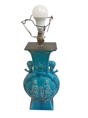 Lot 5063 - Antique Chinese/Japanese porcelain turquoise glazed lamp of moonflask shape, decorated with figures in relief with elephant handles