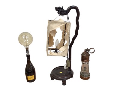 Lot 5064 - Antique copper ships lamp together with a carved Chinese hardwood lamp with a dragons head, together with a converted champagne bottle lamp