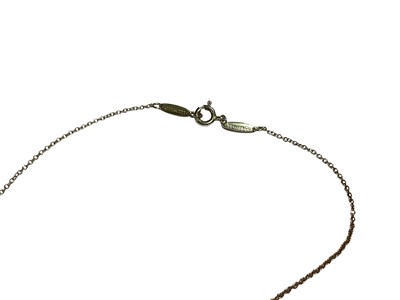 Lot 53 - Diamond and ruby 9ct white gold heart pendant on chain and a diamond and blue topaz silver heart shaped pendant on chain (2)