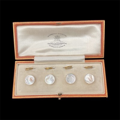 Lot 125 - Set of four 1930s mother of pearl dress studs with 9ct gold loop fastenings, in Goldsmiths & Silversmiths fitted leather box