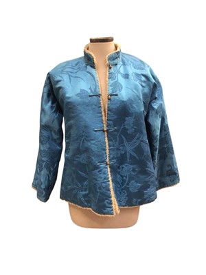 Lot 2503 - Pre-1940s Chinese winter blue silk brocade jacket with lamb fleece lining and metal buttons.