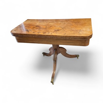 Lot 5397 - Regency mahogany card table, with rounded rectangular hinged top on tapered faceted column and reeded hipped cabriole legs and castors, 104cm wide x 51cm deep x 76cm high