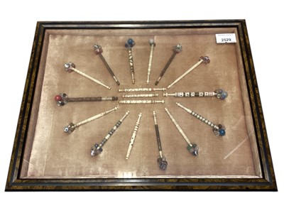 Lot 2529 - Framed group of bone lace bobbins, some with names Richard, Sally, Charlot and Betsy, wire wrapped and turned wood.