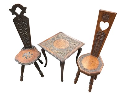 Lot 1362 - Arts and crafts carved square wooden table and two Welsh harpists chairs (one downstairs).