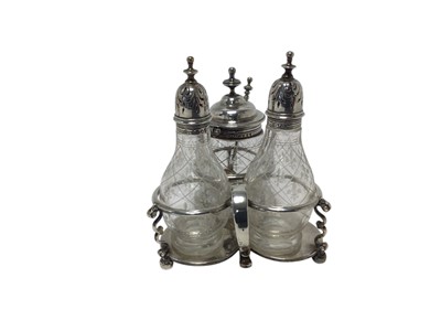 Lot 357 - Victorian silver cruet set, the trefoil stand with engraved crest on thumb piece