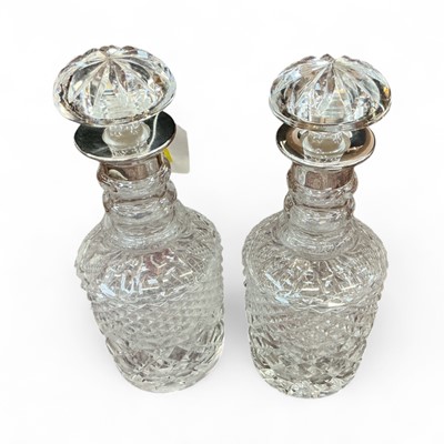Lot 544 - Pair of Georgian style glass decanters with silver collars and mushroom stoppers, London 1966