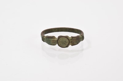 Lot 691 - Post Medieval copper-alloy fede ring with two open hands meeting at a central circular disc/ bezel, possibly 17th / 18th century