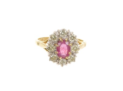 Lot 661 - Ruby and diamond cluster ring with an oval mixed cut ruby surrounded by eight brilliant cut diamonds in a claw setting on 18ct gold yellow gold shank
