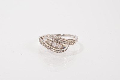 Lot 625 - Diamond dress ring with baguette cut and brilliant cut diamonds in a crossover design in 18ct white gold setting
