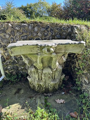 Lot 1930 - Pair of 18th century English carved stone classical capitals with scrolling mounts, later applied lead tops, 52cm high overall