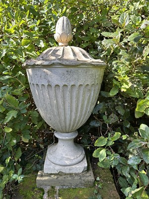 Lot 1941 - Antique Coade stone urn, the foliate knop above a domed cover and fluted body, circular socle and square base, approximately 60cm high