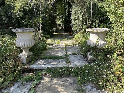 Lot 1942 - Pair of antique stone garden urns with half reeded bodies, on square bases, 61cm high