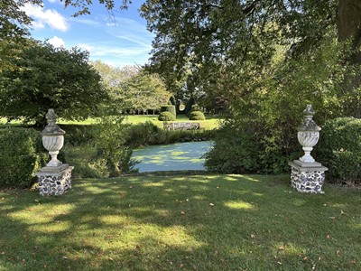Lot 1949 - Pair of antique garden urns of wrythen fluted form, on square bases and superstate square plinths, 100cm high overall
