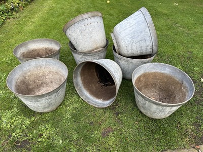 Lot 1950 - Set of eight galvanised garden planters of slightly tapered form, on circular bases, 35cm high