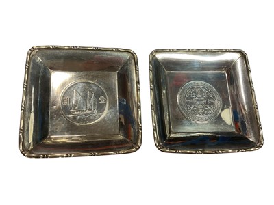 Lot 127 - Pair of sterling silver square pin dishes each inset with a Chinese coin, 9cm