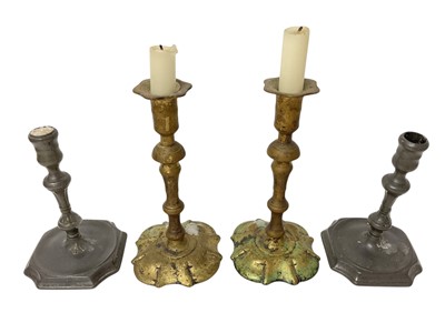 Lot 1876 - Pair of Queen Anne brass candlesticks, 20.5cm high, and a pair of 18th century pewter candlesticks
