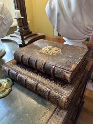 Lot 1882 - Two deceptive book boxes, the 18th century leather bound tomes adapted with internal spaces to hide secrets, largest 29cm high