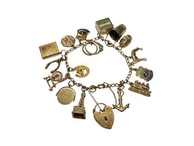 Lot 139 - 9ct gold charm bracelet with sixteen 9ct gold novelty charms and 9ct gold padlock clasp