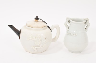 Lot 212 - Chinese blanc de chine teapot, probably 17th century, of octagonal form each side moulded in relief with a prunus spray, with white metal spout, 14.5cm from spout to handle, together with a smal...