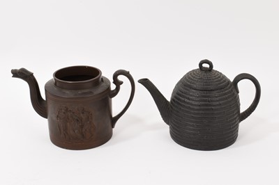 Lot 207 - English pottery teapot, circa 1800, finely decorated in relief in the Neoclassical style with figural scenes, serpent form teapot and scroll handle, together with a basalt teapot in the form of...