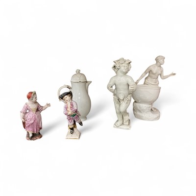 Lot 77 - Group of antique continental ceramics, including a Berlin figural sweetmeat, a German cream jug, two small German porcelain figures, and a pearlware putto (5)