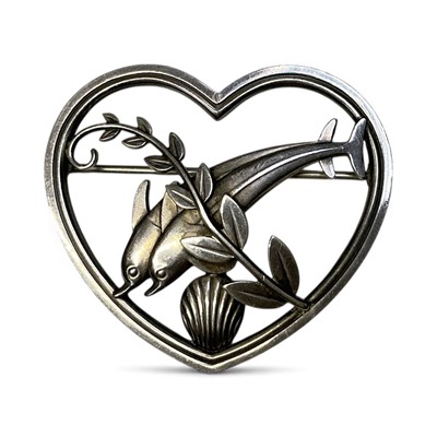 Lot 2 - Georg Jensen Danish sterling silver heart shaped brooch with two dolphins swimming amidst seaweed and a shell, designed by Arno Malinowski, no. 312