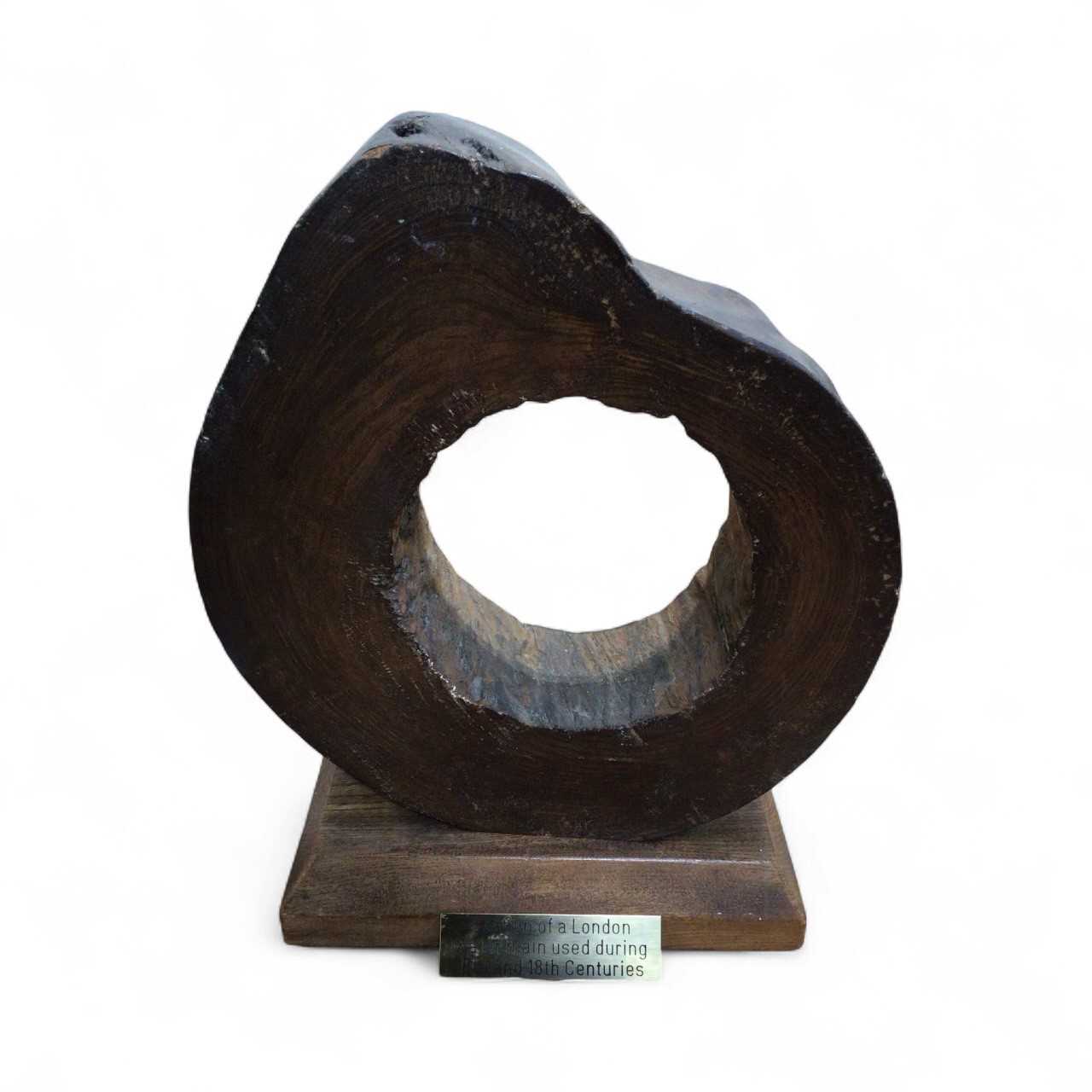 Lot 5022 - Section of a London water main used during the 17th and 18th centuries, mounted on a wooden base