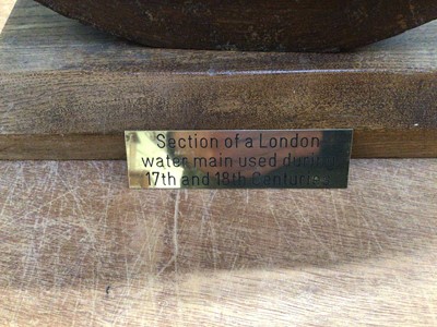 Lot 5022 - Section of a London water main used during the 17th and 18th centuries, mounted on a wooden base