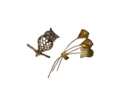 Lot 16 - 9ct gold novelty owl brooch with a diamond set face and ruby eyes, together with a yellow metal and seed pearl floral spray brooch (stamped 18K)