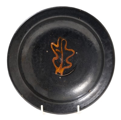 Lot 1898 - *Bernard Leach CBE (1887-1979) black glazed pottery dish, with slip-trailed oak leaf under an amber glaze, possibly dating from around 1932, impressed 'BL' to base, with another impressed mark, 2...