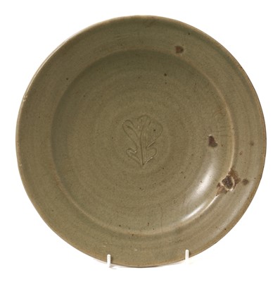 Lot 1899 - Attributed to Bernard Leach CBE (1887-1979), celadon glazed dish with incised oak leaf decoration, impressed St. Ives mark to back, 26cm diameter