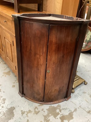 Lot 1332 - George III mahogany bowfront corner cupboard