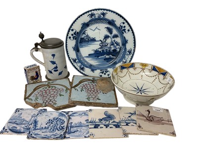 Lot 1909 - Group of mostly 18th century delftware, including a blue and white tankard, a blue and white dish, a polychrome bowl, a small model of a book, and several tiles