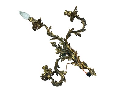 Lot 1253 - Gilt metal three branch wall light, in Louis XV style