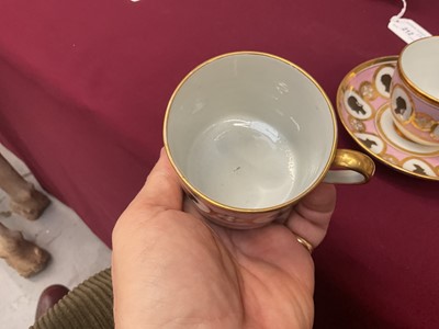 Lot 54 - Coalport trio, unusually painted with profile silhouettes, on a pink ground, circa 1805, pattern number 360