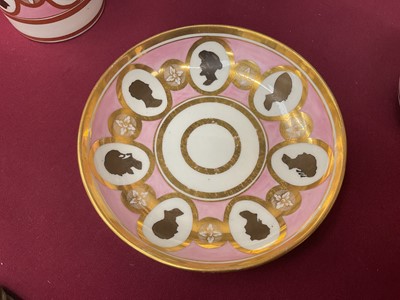 Lot 54 - Coalport trio, unusually painted with profile silhouettes, on a pink ground, circa 1805, pattern number 360