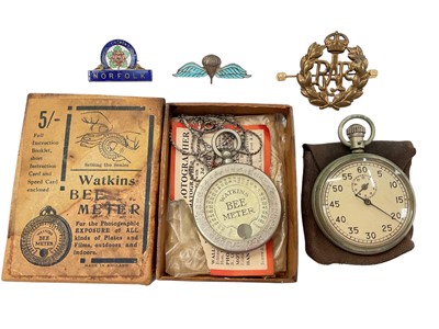 Lot 939 - Military pocket watch, silver and enamel parachute brooch, two other badges and Watkins Bee Meter in original box